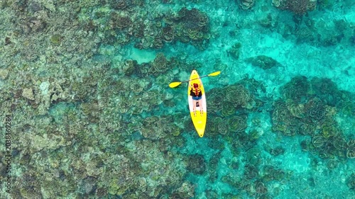 Aerial view of woman traveller exploring calm tropical bay ,Travel and Active Lifestyle concept	