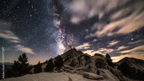 Majestic Milky Way Galaxy Arches Over Rugged Mountain Peaks Under Starry Night Sky.