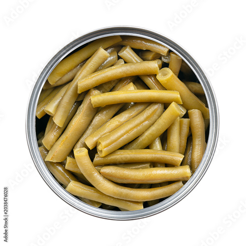 Canned cut green beans in open tin can. Trimmed, young green bean pods, sliced crosswise into uniform pieces, pressure-cooked and sealed in water-based canning. Isolated, close-up, from above. Photo.