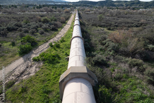 View of large water pipe crossing a river valley in Southern California.