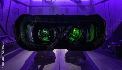 Close-up view of futuristic night vision goggles with green-tinted lenses showing an immersive virtual reality.
