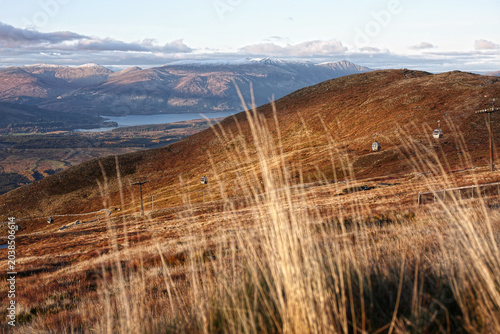 Glencoe mountain resort chair lift cars view through golden grasses