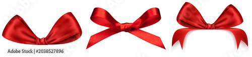 three luxurious red satin ribbons, artfully tied into elegant bows, presented individually against a pristine transparent background, perfect for gifts.