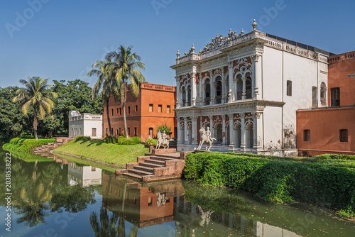 Colorful landscape view of Boro Sardar Bari ancient palace pond facade with reflection in water, Sonargaon, Bangladesh
