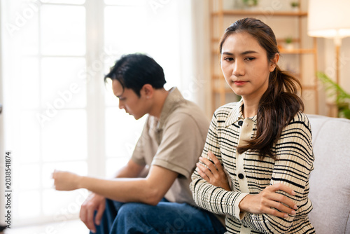 Bild auf Leinwand Relationship problems family crisis asian couple divorce marriage sad worried man husband thinking solution contemplating offended woman wife sitting in living room