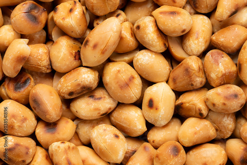 pile of roasted hulled peanuts for background. top view