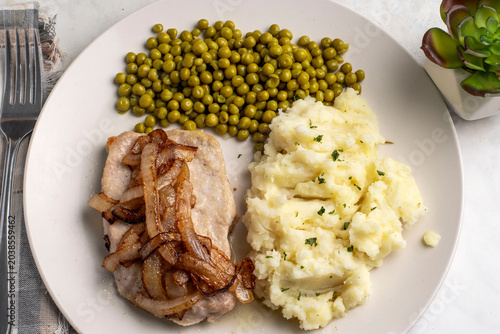 porkchop  with  mash potatoes  top with herbs