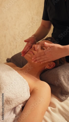 Facial Massage in Spa Salon Slow Motion, Vertical Video Cozy Warm Light Atmosphere