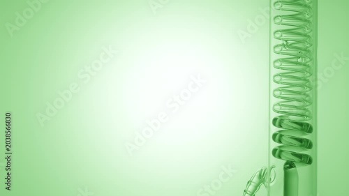 Transparent green liquid flows through a vertical coil lab condenser, filling the coiled glass tube on the right side of the frame, leaving the left side as copy space on green ramp background