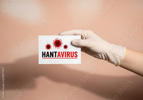 Hantavirus warning sign held by gloved hand