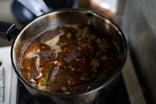 Photos Reheating Northern Thai Noodle Soup In A Pot On Picnic Stove