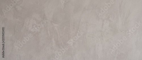 Fotografie The background of the polished smooth cement surface is a warm gray color