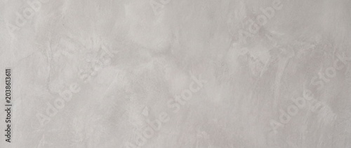The background of the polished smooth cement surface is light gray.