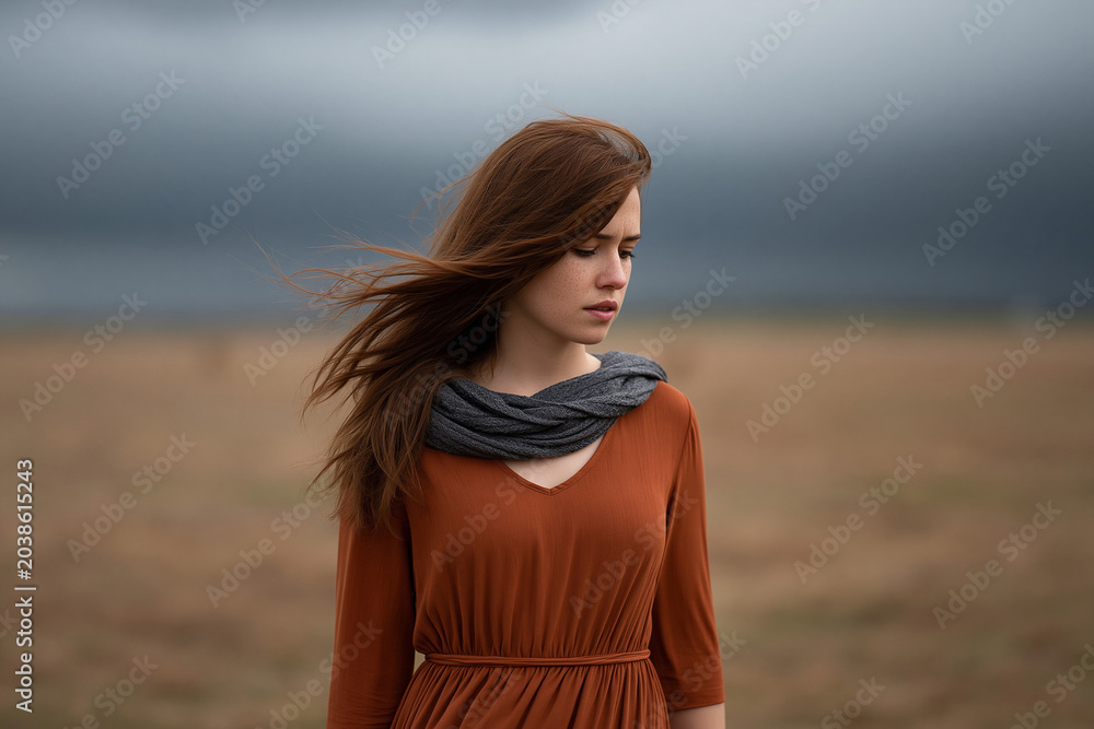 Fototapeta premium Model in fields, wind blowing, cloudy day