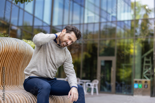 Принти на полотні Man suffering from neck pain and stiffness outdoors