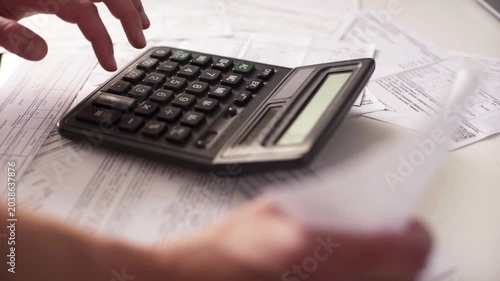 Accountant Hands Using Desktop Calculator and Checking Invoices