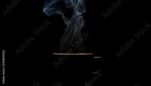 dark coffee cup background with visible steam and studio light accentuation
