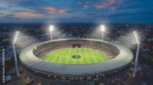 Blurred aerial view of illuminated football stadium at night