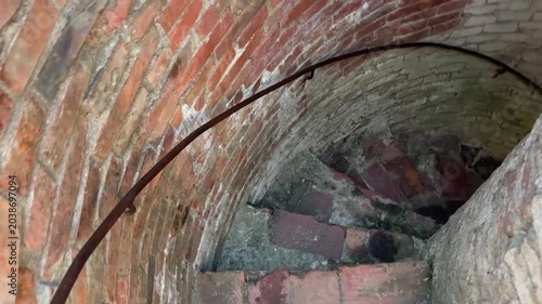Going down old stone medieval spiral stairs