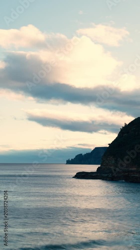 Time-lapse of scenic coastline and dramatic cliffs at dusk, viewed from Maingon Bay Lookout in Tasmania, Australia (Vertical, PANNING)