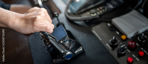 Fotografie Captain hand holding throttle control or engine control lever on modern boat dashboard in wheelhouse or ship bridge