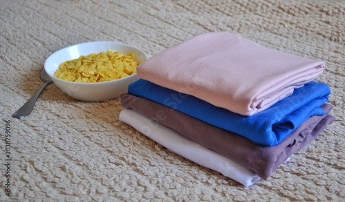 Bild auf Leinwand Perfect morning routine: a healthy breakfast of cornflakes and a fresh stack of home textiles