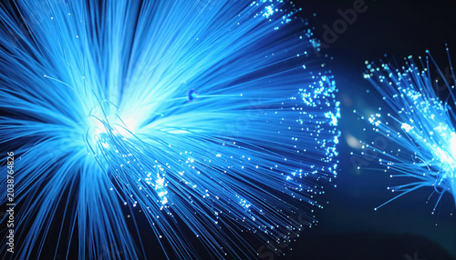Abstract glowing blue fiber optics with bokeh on dark background