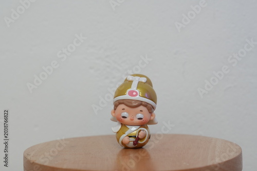 JAKARTA, INDONESIA - JULY 4, 2026: A cute designer miniature collectible toy dressed in traditional Chinese attire on a small wooden stool