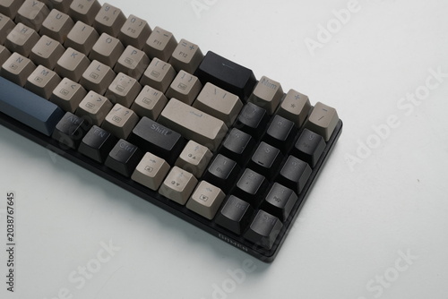 Close up high angle view of a custom mechanical keyboard with dark gray and black keycaps