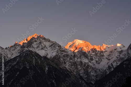 Photography Dramatic sunset photograph of the Kinner Kailash range where the peaks are glowi