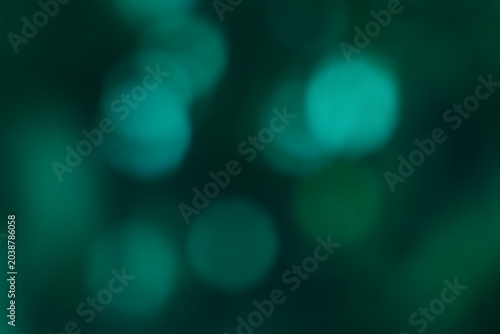 Abstract green bokeh background with blurred glowing