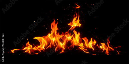Obraz na plátně A blazing fire with orange and red flames burns brightly on a black background,