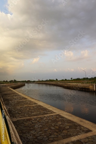 an artificial reservoir or dam with calm water