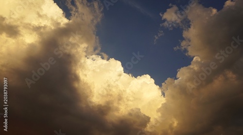 beautiful sunset, the evening sky with black clouds is a sign of the coming night, with yellowing rays of sunlight