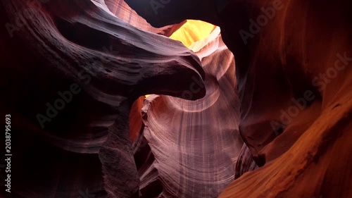 Famous red sandstone walls of antelope canyon showing beautiful textures and curves while sunlight from above creates stunning light and shadow plays in this iconic slot canyon near page, arizona