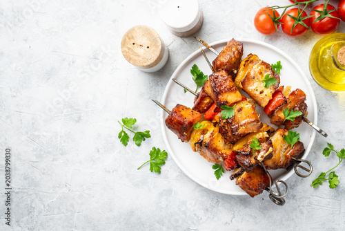 Foto Grilled shish kebab or meat skewers with vegetables.