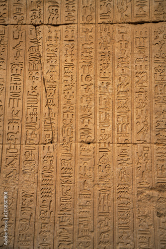 Epic ancient Egypt stone wall hieroglyphics texture background carved relief pattern.
