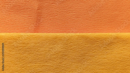 Valokuva Horizontal split two-tone crepe paper texture background in apricot salmon pink and warm mustard yellow