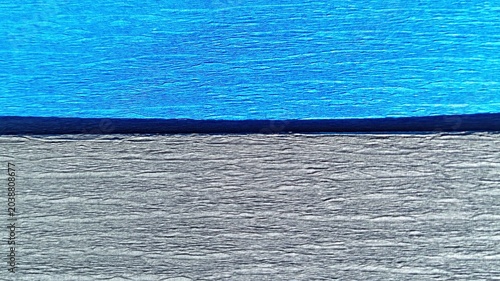 Bilde på lerret Horizontal split two-tone crepe paper texture background in electric blue and charcoal grey