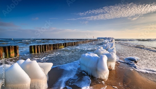 Stacked Ice Floes On The Baltic Sea With Blurry Ice In Foreground And Endless Blue Ice In Background