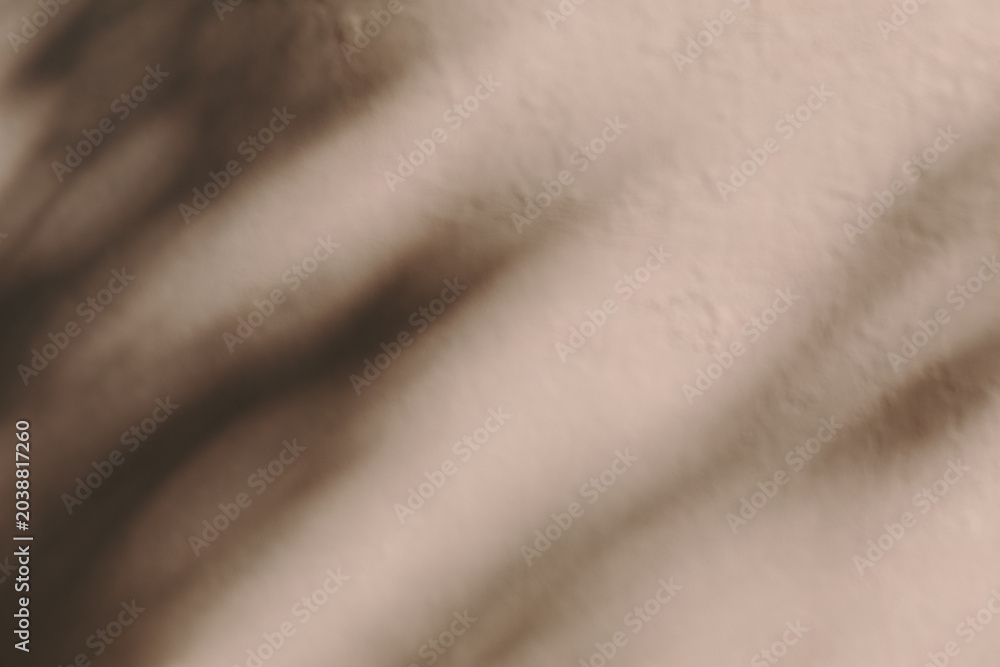Naklejka premium A blurred abstract background showing soft diagonal shadows in warm brown tones, abstract design, minimalist backdrop, artistic shadow play.
