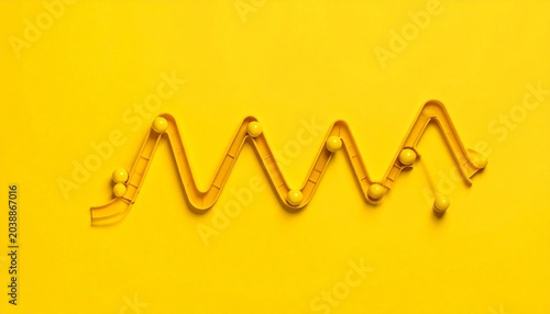 Zigzag Yellow Straw with Spheres on Bright Background Showcasing Minimalist Geometry and Creative Photography Design