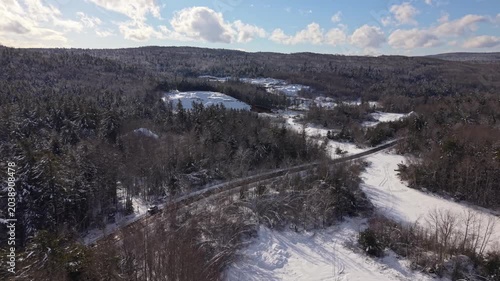 Experience the thrill of skiers gliding down pristine slopes surrounded by stunning winter landscapes in Nova Scotia, Canada. Enjoy the beauty of nature under a clear blue sky