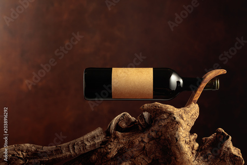 Photos Bottle of red wine with empty paper label.