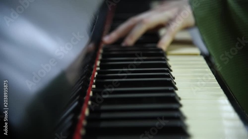 female pianist hands on black and white piano keyboard, close-up view, young woman playing piano, professional musician