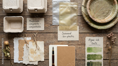 Flat lay of sustainable packaging prototypes featuring mushroom composite seaweed bio-plastic and algae ink tests