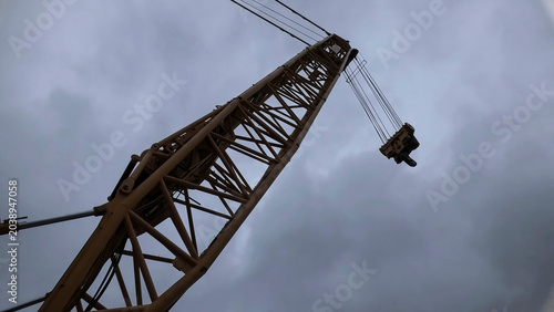 Cuadro en lienzo Tower crane jib seen from below against a cloudy sky
