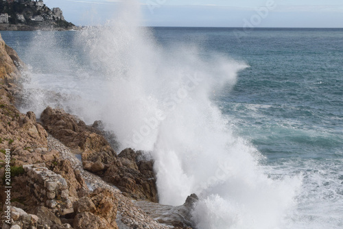 A wave splashes against coastal rocks in the South of France