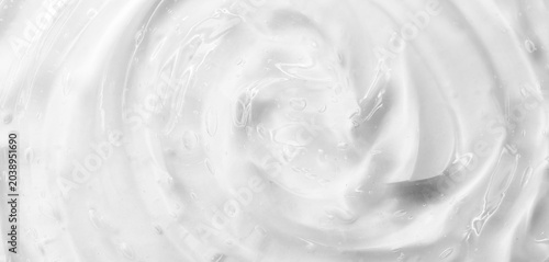 Cosmetic gel, serum transparent sample. Liquid cream with bubble texture. Gel texture of a cosmetic product. Clear liquid lotion for skin care.