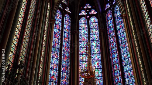 Stained glass windows and illuminated altar inside Amiens Cathedral in France